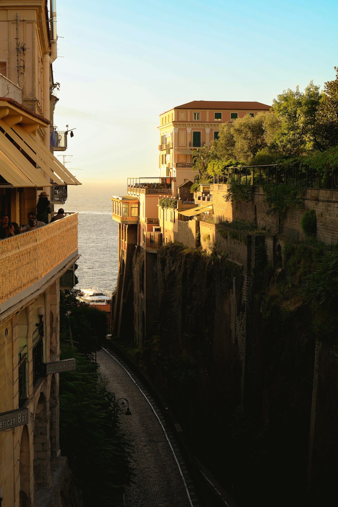 Scenic terrace overlooking a Mediterranean coastal town at sunset