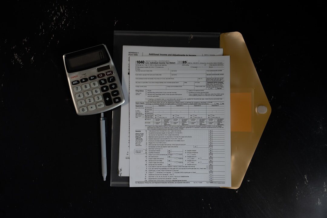 Desk with financial documents, calculator and pen viewed from above